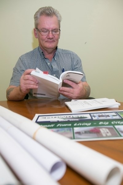 Retiring Bowden chief administrative officer Andy Weiss researches the Alberta Municipal Act. Yesterday was his last official day of work.