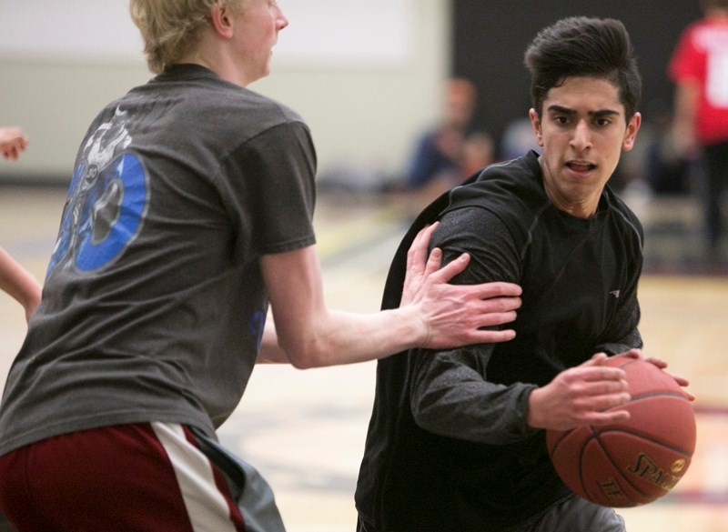 Olds High School senior boys basketball player Sukhraj Dhaliwal drives to the hoop during the team&#8217;s practice on Jan. 20.