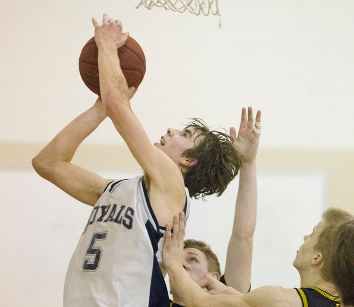 Olds Koinonia Christian School Royals senior boys basketball player Spencer Parrott drives to the hoop during the Royals&#8217; game against the Olds High School Spartans at