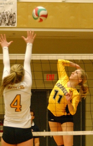 First-year leftside Tara Yuha rises for a spike against the Medicine Hat College Rattlers on Feb. 20. The Broncos women&#8217;s volleyball team lost the match 3-2 but earned