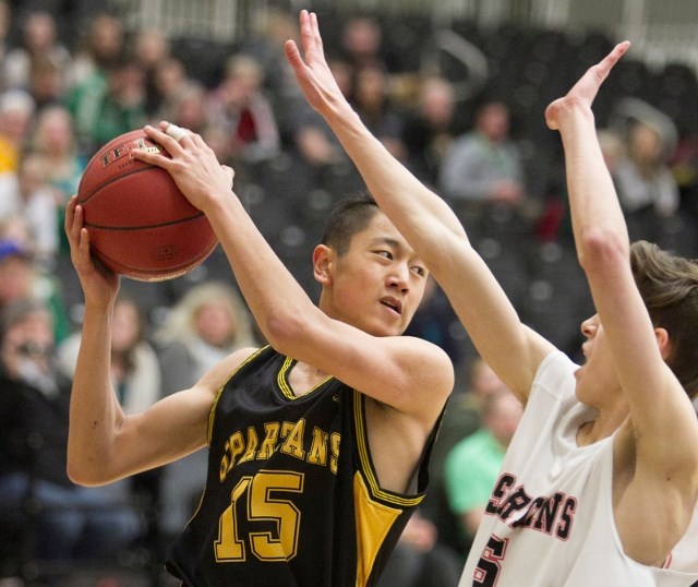 Olds High School Spartans basketball player Jack Jinn looks for a pass during the Spartans&#8217; game against the Spruce Grove Spartans at Olds High School on March 17.