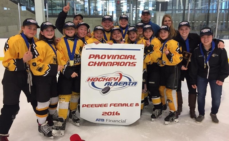 The Olds peewee female Grizzlys celebrate winning the Peewee Female B Provincial Championship, held in Edmonton from March 10-13.