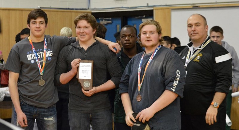 Boys on Olds High School&#8217;s wrestling team. From left, Kevin Waldron, Seth Quilley, Menwo Teah, Luke Daley, coach George Grant. Absent: William Reiswig. The boys won the 