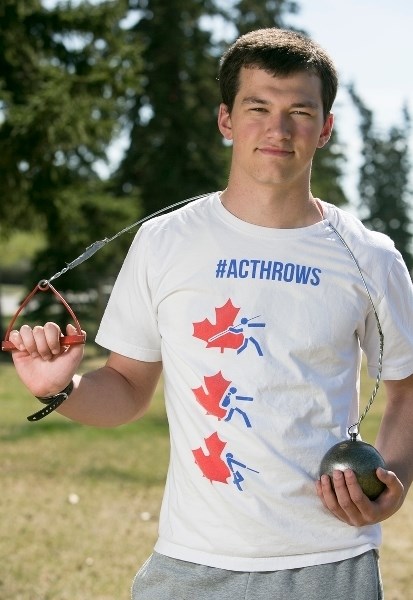 Andreas Troschke, who recently won a bronze medal in the hammer throw at the Oregon Relays track meet, holds some of his gear.