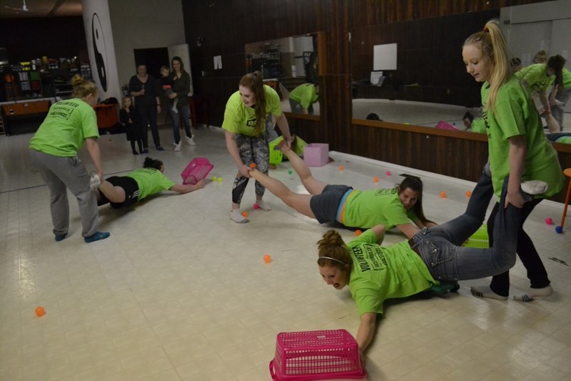 Members of the Olds Broncos female hockey team try out one of the proposed Race for Kids checkpoint activities: the &#8220;human hungry, hungry hippos.&#8221;