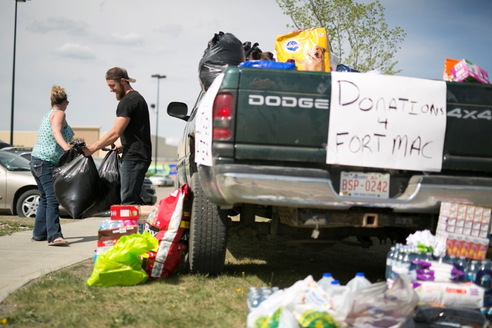 &#8203;Jannelle Galpin, left, drops off donated items with Jordon Rhude, who will be transporting the items to the Fort McMurray area for people affected by the wildfires