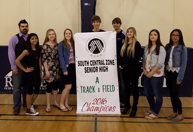 From left, Olds Koinonia Christian School&#8217;s track and field team poses with the first zone banner in its hi coach Ken Terpstra, Mikaela Padiernos, Jewel Stewart, Ashley 