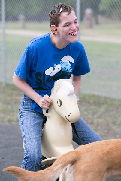 Horizon School student Keesha Grills plays at the school&#8217;s new playground during the grand opening ceremony.