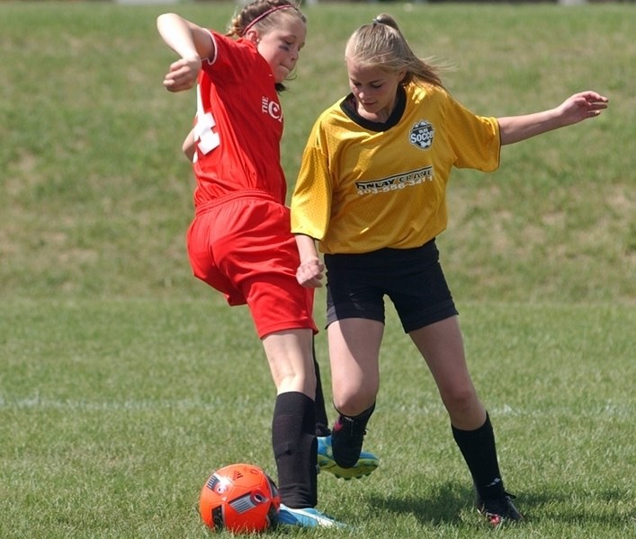 Olds Minor Soccer Club&#8217;s Elise Schaber fighting for possession against Three Hills on June 11 at the 2016 Big Country Soccer District Finals in Carstairs.