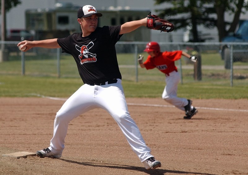 Mike Prysunka of the Olds bantam AA Spitfires pitches from the stretch as an Innisfail Indians player makes a run for it on June 26 at O.R. Hedges Park. Innisfail beat Olds