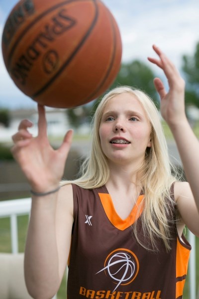 Amelia Furst shows off her ball handling skills at her home in Olds.