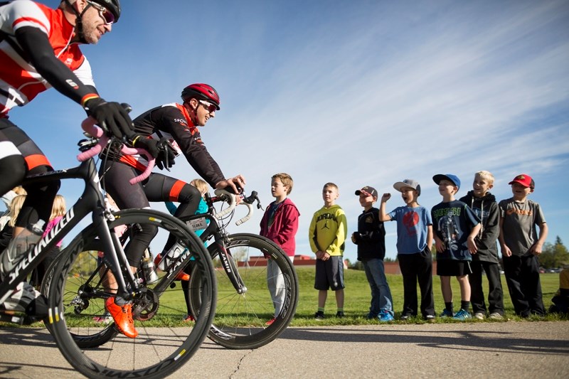 Jumpstart riders make their way around a track behind Ecole Olds Elementary School.