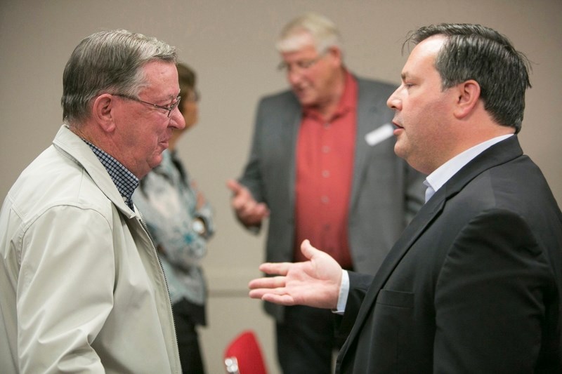 Progressive Conservative leadership candidate Jason Kenney (right) speaks with former Olds-Didsbury-Three Hills MLA Bruce Rowe during the Olds-Didsbury-Three Hills PC party