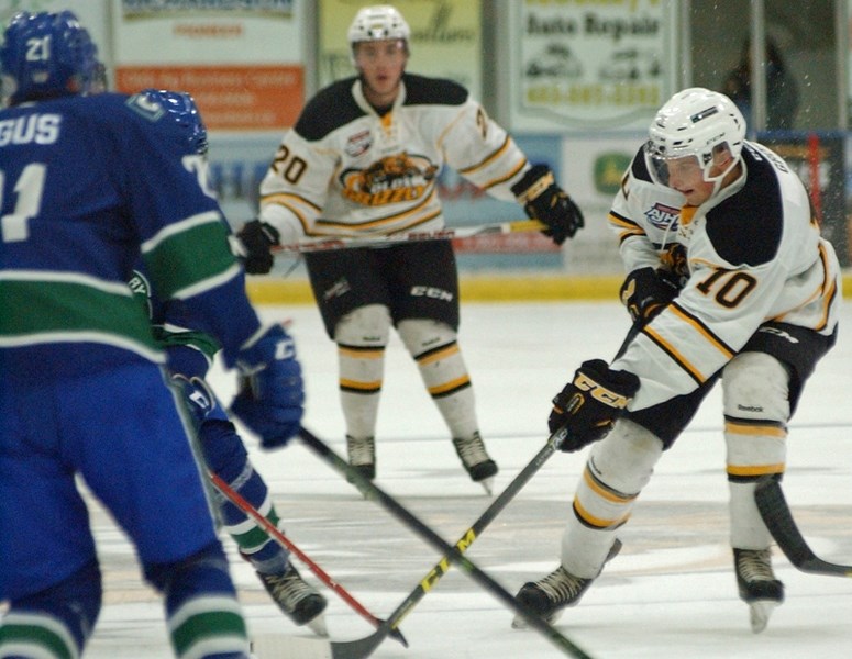 Grizzlys forward Landon Gross (No. 10) tries to keep possession of the puck through the neutral zone during his team&#8217;s home opener on Sept. 17. Olds beat the Calgary