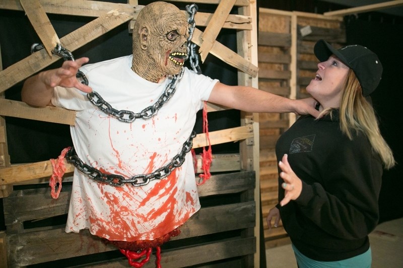 Dean, left, and Miranda Watson pose for a photo in the haunted house set up at the Boys &#038; Girls Club of Olds &#038; Area on Oct. 24. The haunted house will be open from