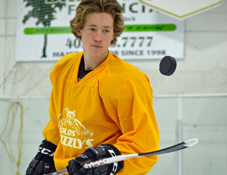 Hometown Olds Grizzlys forward Chase Olsen shows some hand-eye coordination during practice.