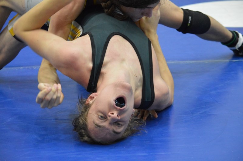 Cole Urbanowski uses the bridge move to avoid being pinned during a meet in Wetaskiwin.