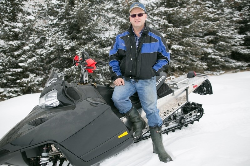 Olds Snowmobile Club president Lyle Statham sits on a sled at his home. Statham arranged a meeting at the Olds Legion to discuss the province&#8217;s decision to ban quads