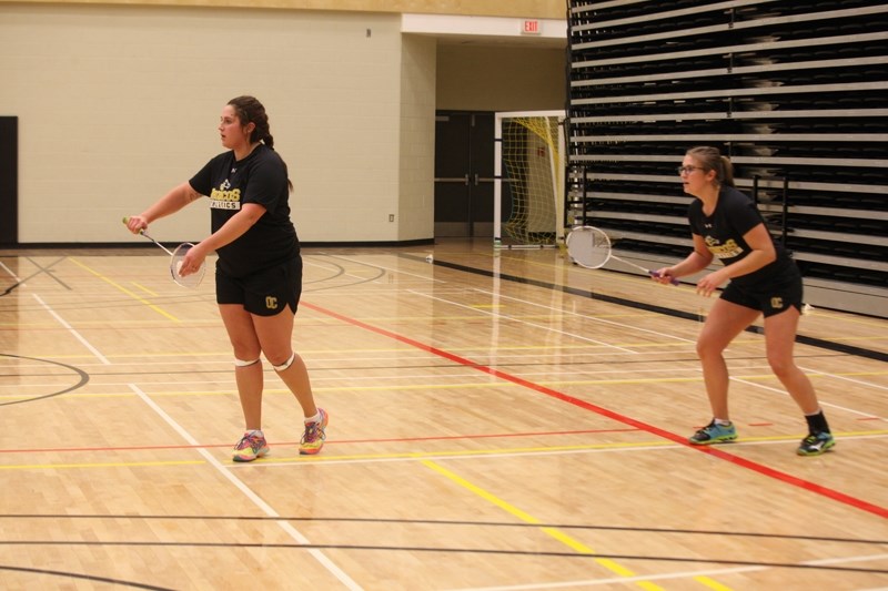 Layce Donaldson prepares to serve as partner Sherry Hahn readies for the return in their bronze medal match.