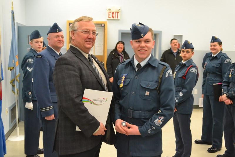 Red Deer-Mountain View MP Earl Dreeshen and Warrant officer first class Ryland Sturrock pose with the Duke of Edinburgh&#8217;s gold award and accompanying document.