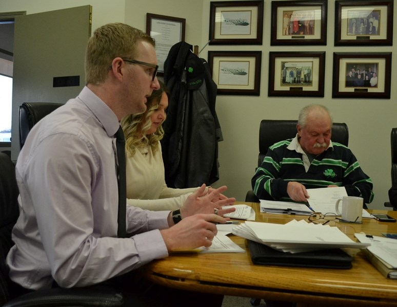 Ryan Wachter, manager of BDO Canada LLP explains the firm&#8217;s audit of the town of Bowden&#8217;s books as Coun. Wayne Milaney looks through the report. On hand for the