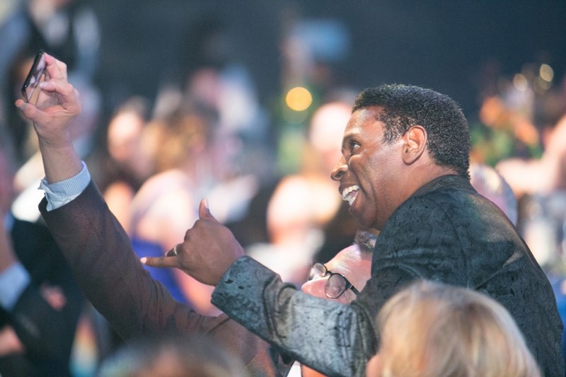 Michael &#8220;Pinball&#8221; Clemons poses for a selfie with a guest during his keynote speech at the Olds College Gala March 24.