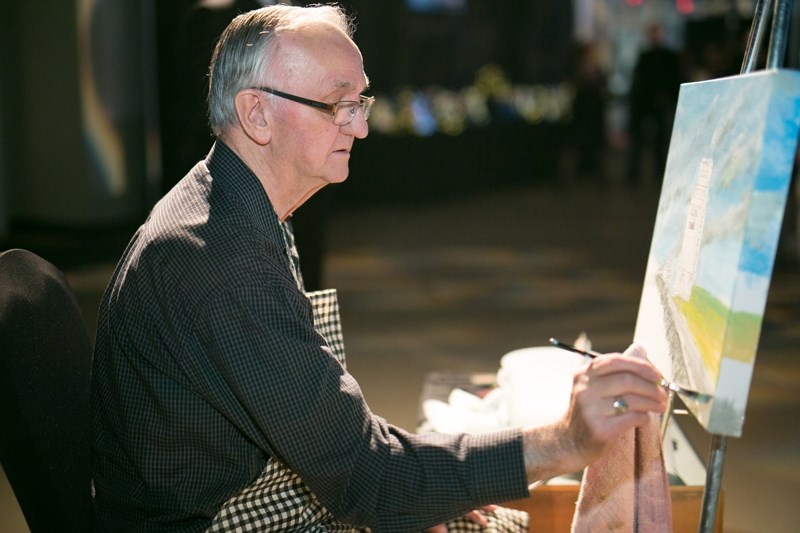 Al Gagne will be the featured artist at this weekend&#8217;s Olds Art Club show and sale at the Evergreen Centre. Here, he works on a painting during the Olds College Gala.