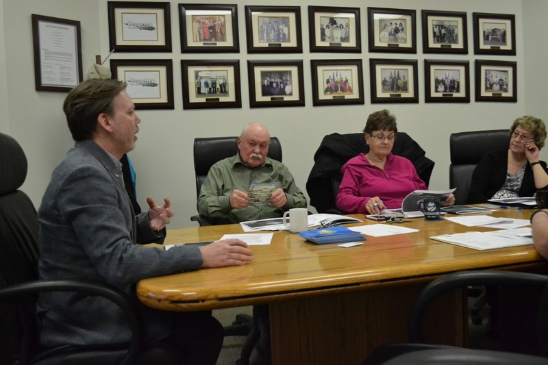 Jason O&#8217;Connor of Axia community relations, far left, pitches the idea of Axia installing communications fibre in Bowden to members of Bowden town council. Looking on