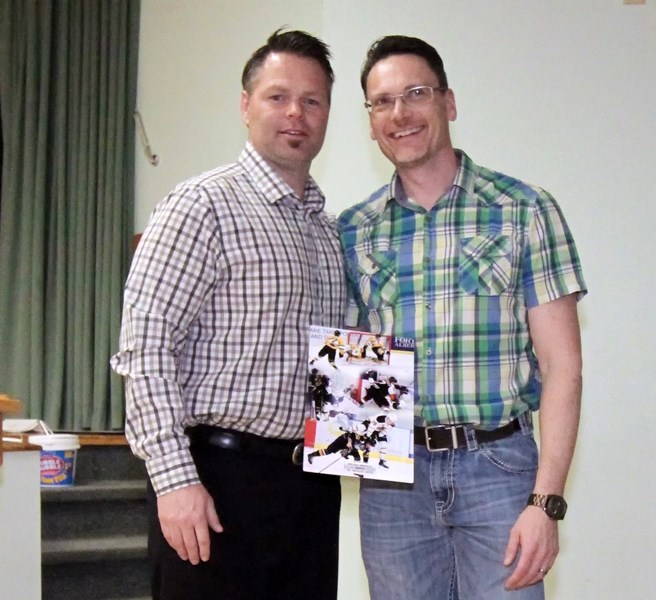 The Grizzlys chiropractor Dr. Michael Lentz, right, was presented with the Bob Hill Memorial Award by assistant coach Jeramie Heistad, left, last Friday (April 21) during the 