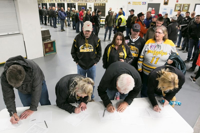 People register for a meeting on survival of the Olds Grizzlys Junior A hockey team at the Olds Sportsplex.