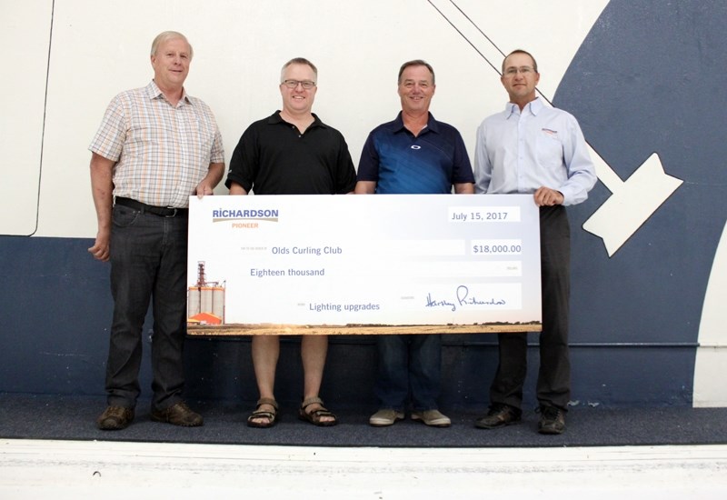 Richardson Pioneer director of operations Mile Dezall, far right, presents a cheque for $18,000 to the Olds Curling Club representatives, from left Brian Winter, ice