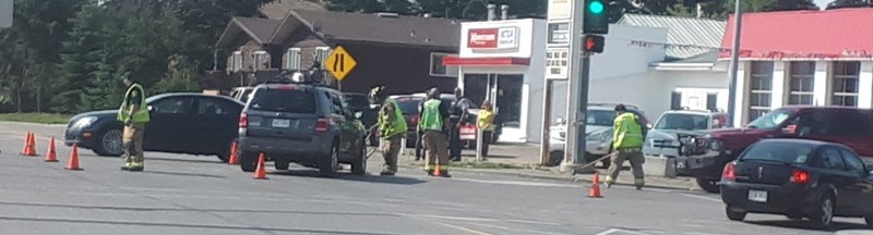 Members of the Olds Fire Department clean up the scene after collision occurred at the interesection of Highways 2A and 27 Monday, Aug. 7.