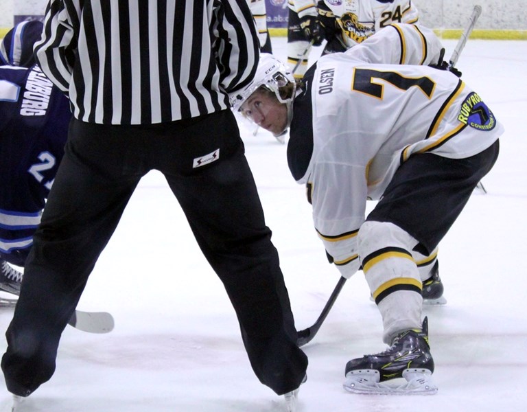 Chase Olsen faces off during a Grizzlys hockey game.