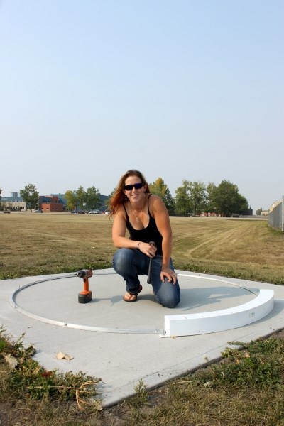 Olds High School track and field coach Rachel Andres spearheaded a campaign to get proper throwing rings installed at the high school.