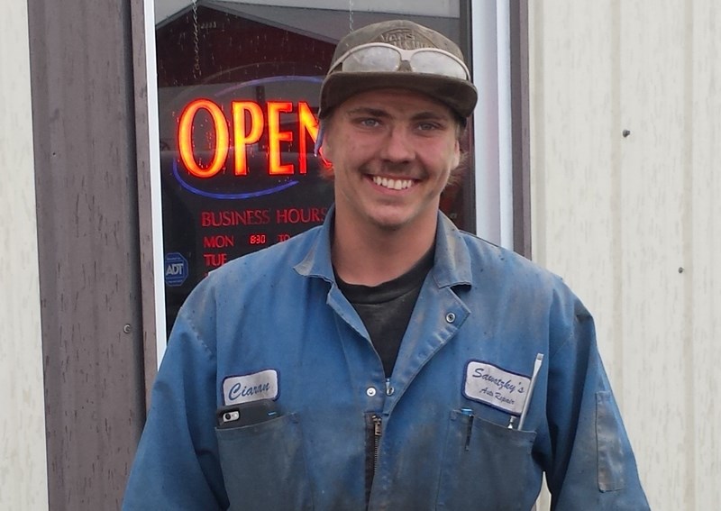 Chase Hanson of Bowden stands outside Imperial Heavy Truck Repair in Olds. Hanson is taking a program that allows him to work part time in the shop and gain valuable