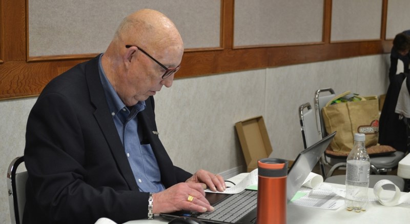 Returning officer Bill Johston tabulates the results in the Olds civic election.