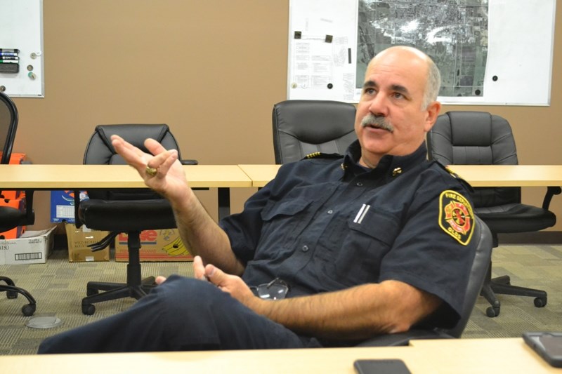 Olds Fire Chief Mike Hoffman ponders the answer to a question during an interview with the Albertan.