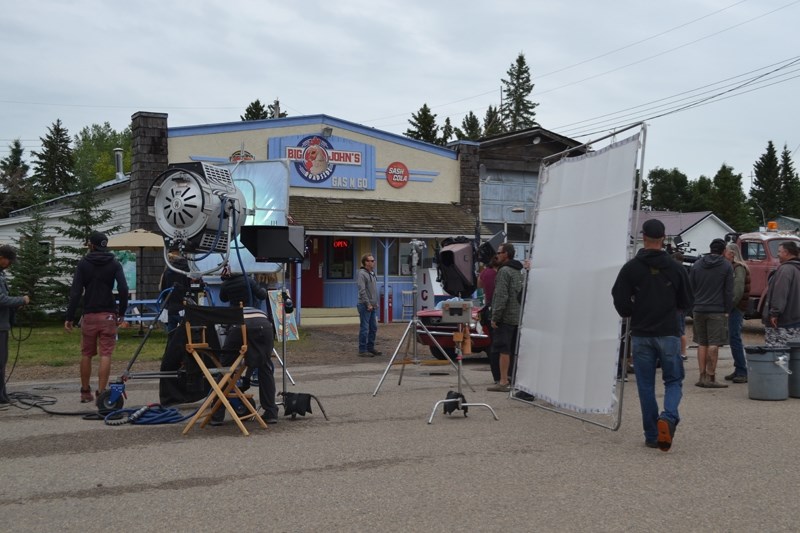 Lighting crews get equipment ready for the next scene shot outside Pizza &#8216;N&#8217; More Eh! on Aug. 1.