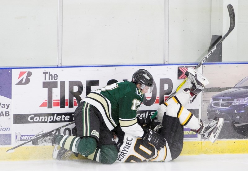 Olds Grizzlys player Josh Borynec hits the boards during the Grizzlys&#8217; game against the Okotoks Oilers at the Olds Sportsplex on Nov. 11. The Grizzlys won the game 3-2