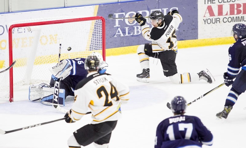 Olds Grizzlys player Jared Power scores on the Canmore Eagles goaltender during the teams&#8217; game at the Olds Sportsplex on Nov. 25.