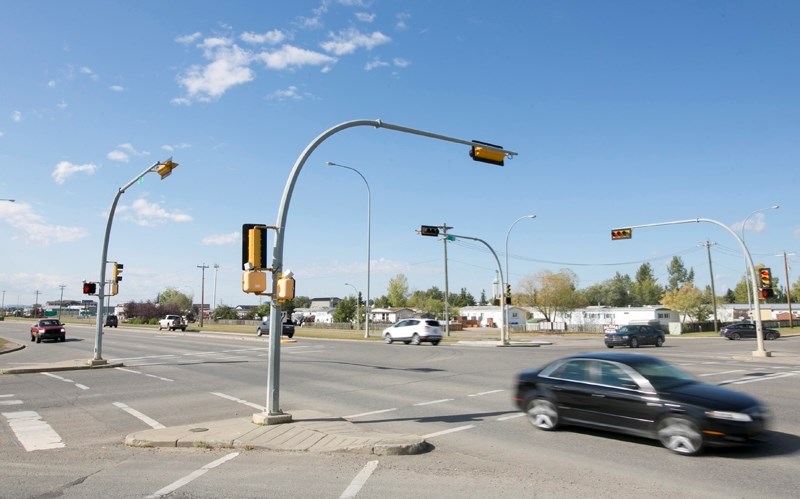 Vehicles travel through the intersection of 57 Avenue and 46 Street.