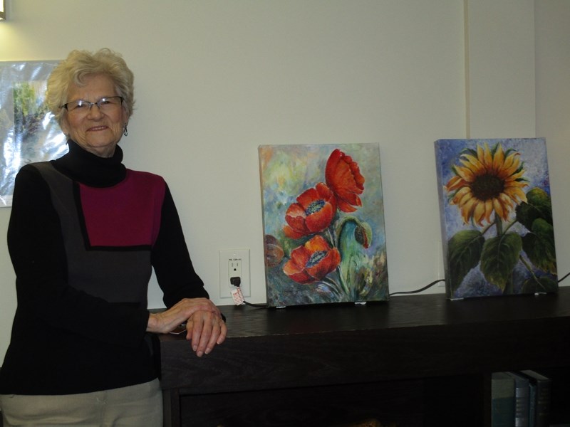 Elsie Bonkowski poses with some of her artwork.