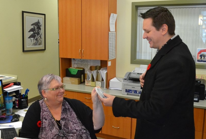 Illusionist Derek Selinger performs card trick for Joanne Teuling. Selinger&#8217;s show, The Gift, begins at 7:30 p.m. Dec. 8 at the TransCanada Theatre.