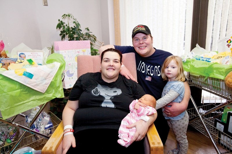 Taren and Kyle Hamm with their new daughter Dakota and her sister Bella Grace at Olds hospital last Thursday.