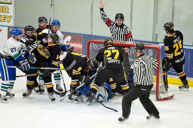 A pileup forms at the Grizzlys&#8217; goal during the game.