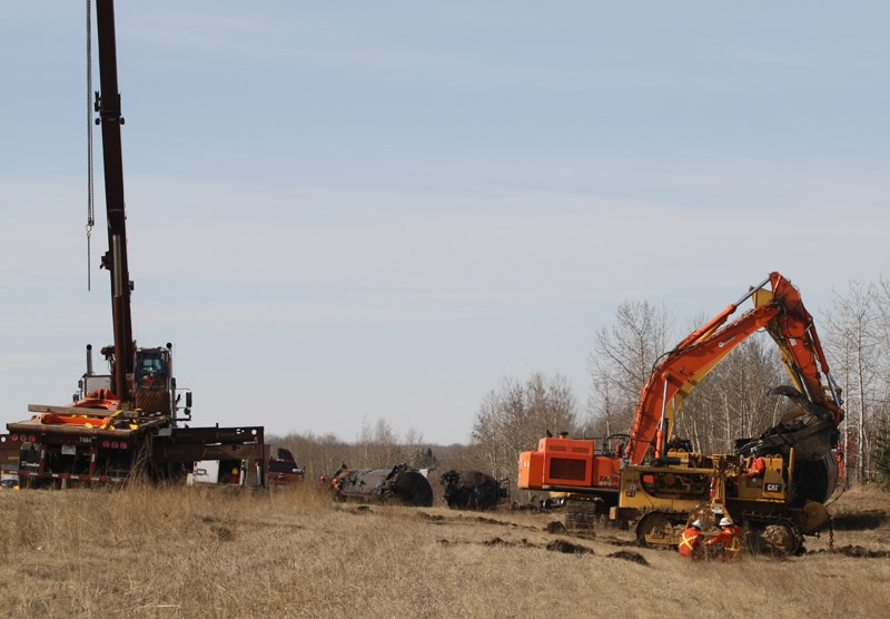 Crews work to clean up a train derailment north of the Bowden Federal Penitentiary Saturday morning.