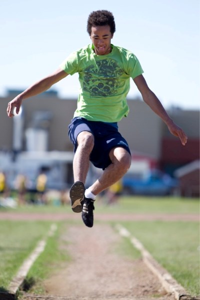 Olds Koinonia Christian School student Taylor Brown competes in the triple jump event during the trcak meet.