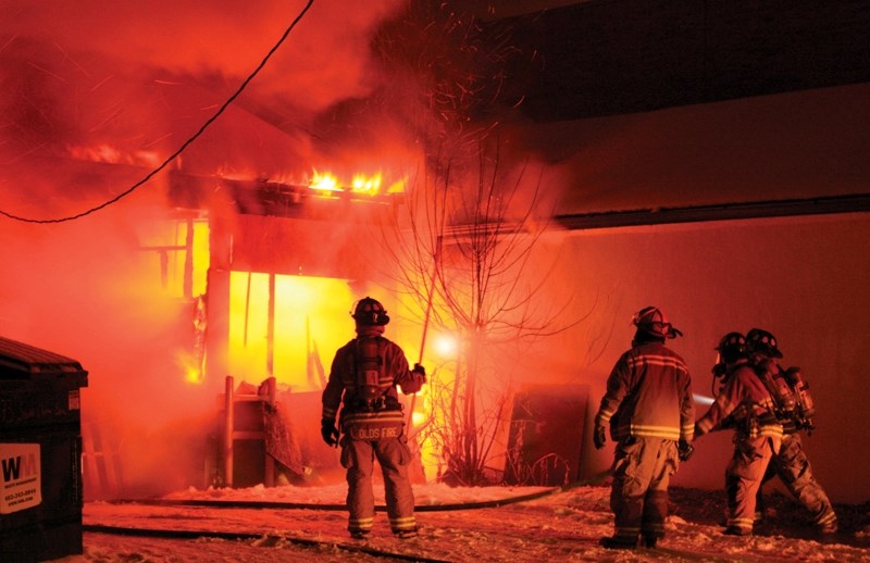 Members of the Olds Fire Department battle a blaze that erupted out of the back of Paint Pot on 50th Street in Olds Saturday night around 8:30 p.m. Business owner Brad