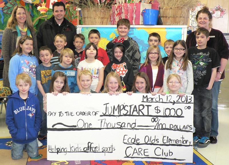 Ecole Olds Elementary School teacher Debbie Unger, Glenn McLean, Canadian Tire Jumpstart Charities&#8217; regional manager of Western Canada, and Katharine Doyle, chair of