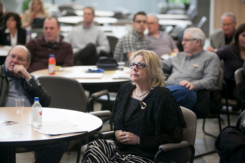 Mayor Judy Dahl and other Olds Institute members, as well as members of the general public, listen to the organization&#8217;s outgoing chair, Rob Smith, speak during the